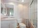 Bright bathroom featuring a granite-topped vanity, decorative storage cabinet and shower with glass door at 6495 Shoreline Dr # 8106, St Petersburg, FL 33708