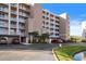 Exterior of building with palm trees and pond at 6495 Shoreline Dr # 8106, St Petersburg, FL 33708
