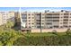 Exterior view of condo building with balconies, palm trees, and lush landscaping at 6495 Shoreline Dr # 8106, St Petersburg, FL 33708