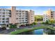 Low angle view of a condominium exterior with pond and car park at 6495 Shoreline Dr # 8106, St Petersburg, FL 33708