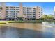 Beautiful condo building overlooking a well-manicured lawn and a pond with a water feature at 6495 Shoreline Dr # 8106, St Petersburg, FL 33708