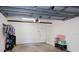 Interior of attached garage with overhead door and additional storage shelves and parking at 6495 Shoreline Dr # 8106, St Petersburg, FL 33708