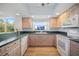 Well-lit kitchen featuring wood cabinets, a garden window above the sink, and modern appliances at 6495 Shoreline Dr # 8106, St Petersburg, FL 33708