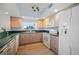Bright kitchen with wood cabinets, modern appliances, and abundant natural light at 6495 Shoreline Dr # 8106, St Petersburg, FL 33708