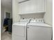 Functional laundry room with washer, dryer and built-in cabinets at 6495 Shoreline Dr # 8106, St Petersburg, FL 33708