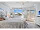 Bright main bedroom featuring a ceiling fan and balcony doors at 6495 Shoreline Dr # 8106, St Petersburg, FL 33708