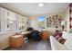 Bright home office with large windows, a ceiling fan, and built-in desk and storage at 6495 Shoreline Dr # 8106, St Petersburg, FL 33708