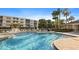 Community pool with surrounding lounge area and lush landscaping offering relaxation and recreation at 6495 Shoreline Dr # 8106, St Petersburg, FL 33708