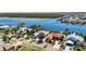 Waterfront home with boat dock and pool, offering stunning aerial views and lush surroundings at 6603 Seabird Way, Apollo Beach, FL 33572