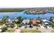 Waterfront home featuring lush greenery, a boat dock, and beautiful views, perfect for relaxation at 6603 Seabird Way, Apollo Beach, FL 33572