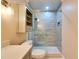 Contemporary bathroom featuring a tiled shower with grab bar, and stylish vanity at 6603 Seabird Way, Apollo Beach, FL 33572