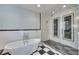 Modern bathroom features a soaking tub and walk-in glass shower with black and white tiles at 6603 Seabird Way, Apollo Beach, FL 33572