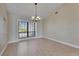 Inviting dining room featuring hardwood floors, chandelier, and large window for natural light at 6603 Seabird Way, Apollo Beach, FL 33572