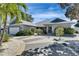 Charming single-story home featuring a well-manicured lawn and a driveway with decorative concrete accents at 6603 Seabird Way, Apollo Beach, FL 33572
