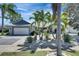 Beautiful home featuring lush landscaping, palm trees, and a well-maintained lawn at 6603 Seabird Way, Apollo Beach, FL 33572