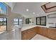 Well-lit kitchen with white countertops, light wood cabinets, and views of the water at 6603 Seabird Way, Apollo Beach, FL 33572