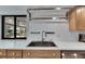 Bright kitchen features a stainless steel sink, light wood cabinetry, and natural light at 6603 Seabird Way, Apollo Beach, FL 33572