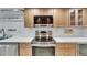 Kitchen features stainless steel appliances, light wood cabinets, and white countertops at 6603 Seabird Way, Apollo Beach, FL 33572