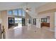Spacious living room with large windows, sliding doors to pool area, and access to the kitchen at 6603 Seabird Way, Apollo Beach, FL 33572