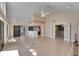 Bright living room with vaulted ceilings, skylights, bar access, and double doors to another room at 6603 Seabird Way, Apollo Beach, FL 33572