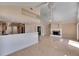Open-concept living space flows from kitchen to the living room with a fireplace at 6603 Seabird Way, Apollo Beach, FL 33572