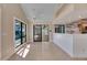 Open-concept living room with a bar area, sliding doors to the patio, and pool view at 6603 Seabird Way, Apollo Beach, FL 33572