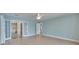 Bedroom featuring hardwood floors, white doors, and an ensuite bathroom with a black and white checkered floor at 6603 Seabird Way, Apollo Beach, FL 33572