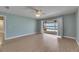 Bright bedroom with hardwood floors, ceiling fan, and sliding glass doors to screened-in patio overlooking the water at 6603 Seabird Way, Apollo Beach, FL 33572