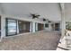 Large patio with brick flooring, multiple ceiling fans, sliding glass doors and a view to a waterway at 6603 Seabird Way, Apollo Beach, FL 33572