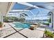 Enclosed pool with brick surround, steps, and a view of the inter-coastal waterway at 6603 Seabird Way, Apollo Beach, FL 33572