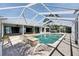 Enclosed pool with brick patio, steps, and a partial view of the waterway in the background at 6603 Seabird Way, Apollo Beach, FL 33572