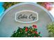 Welcoming community sign 'Cobia Cay' with vibrant flowers and lush greenery at 6603 Seabird Way, Apollo Beach, FL 33572