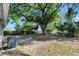 Spacious backyard featuring a large tree for shade and partial fencing at 7101 Kingston Dr, Tampa, FL 33619