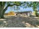 Backyard featuring a large tree for shade, partial fencing, and concrete patio at 7101 Kingston Dr, Tampa, FL 33619