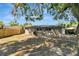 Open backyard features a large tree for shade and partial fencing at 7101 Kingston Dr, Tampa, FL 33619