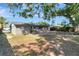Open backyard features a large tree for shade and partial fencing at 7101 Kingston Dr, Tampa, FL 33619