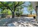 Spacious backyard featuring a large tree for shade and partial fencing at 7101 Kingston Dr, Tampa, FL 33619