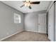 Standard bedroom features neutral walls, ceiling fan, carpet, and window at 7101 Kingston Dr, Tampa, FL 33619