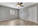 Bright bedroom featuring modern light fixture, sleek flooring, and natural light through windows at 7101 Kingston Dr, Tampa, FL 33619