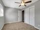 Comfortable bedroom with neutral walls, ceiling fan, closet, and window at 7101 Kingston Dr, Tampa, FL 33619