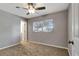 Cozy bedroom featuring plush carpeting, a ceiling fan, and a window providing natural light at 7101 Kingston Dr, Tampa, FL 33619