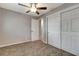 A cozy bedroom with carpeted floors, a ceiling fan, and access to a closet and an adjacent room at 7101 Kingston Dr, Tampa, FL 33619