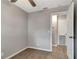 Bedroom features a light gray walls, neutral carpet, and door leading to en-suite bathroom at 7101 Kingston Dr, Tampa, FL 33619