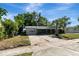 Attractive single-story home featuring a driveway and lush landscaping at 7101 Kingston Dr, Tampa, FL 33619