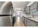 Galley kitchen featuring stainless appliances, sleek countertops, and an open view at 7101 Kingston Dr, Tampa, FL 33619
