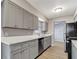 Elegant kitchen featuring gray cabinets, modern appliances, and bright countertops at 7101 Kingston Dr, Tampa, FL 33619