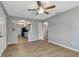Open-concept living area with modern wood floors and neutral gray walls at 7101 Kingston Dr, Tampa, FL 33619