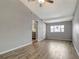 Living room with laminate flooring, ceiling fan, and kitchen view at 7101 Kingston Dr, Tampa, FL 33619