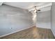Spacious living room featuring laminate flooring, a ceiling fan, and a stairway at 7101 Kingston Dr, Tampa, FL 33619