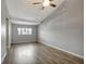 Inviting living room featuring stylish laminate flooring, a ceiling fan, and neutral color palette at 7101 Kingston Dr, Tampa, FL 33619